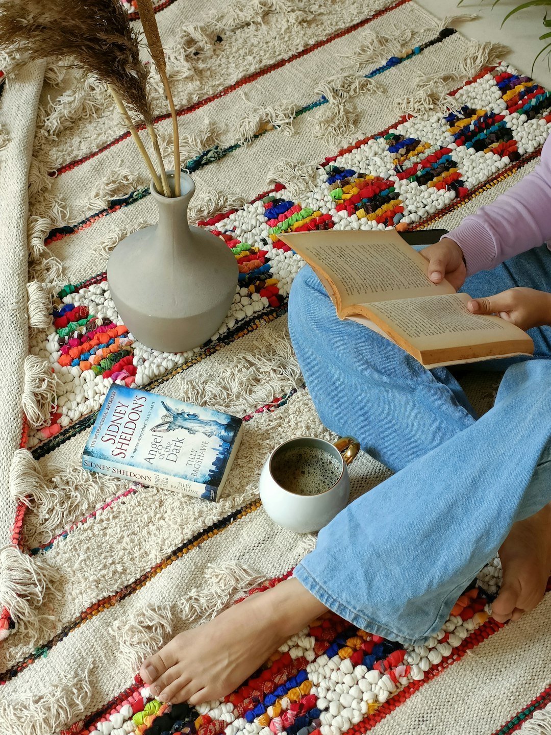 a-woman-sitting-on-the-floor-reading-a-book-hflsuxen9fq